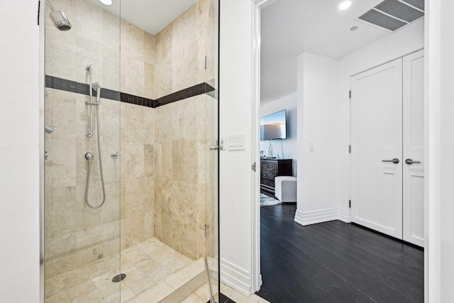 full bathroom with visible vents, a shower stall, baseboards, and wood finished floors