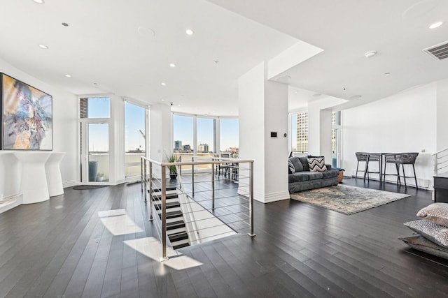 interior space with visible vents, a city view, wood finished floors, recessed lighting, and baseboards