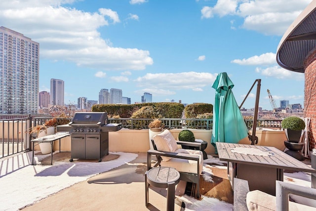 view of patio / terrace featuring a city view and a grill