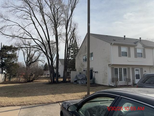 view of property exterior with a yard