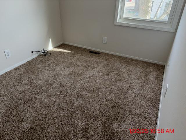 empty room with carpet flooring