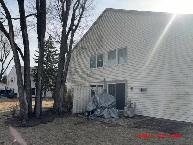 back of house with central AC unit