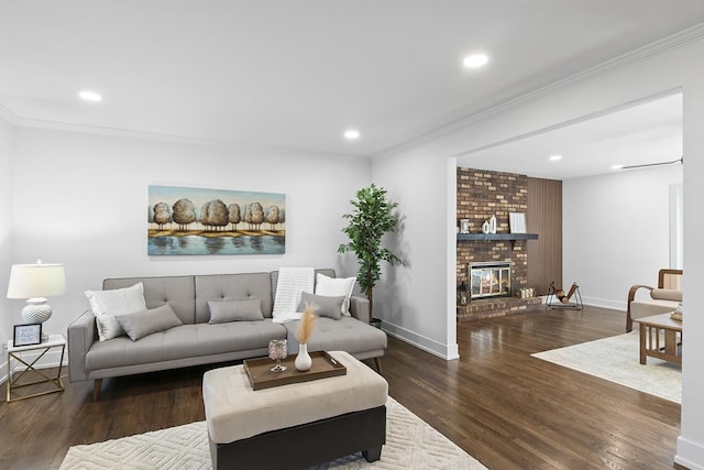 living room featuring a brick fireplace, crown molding, and dark wood-type flooring