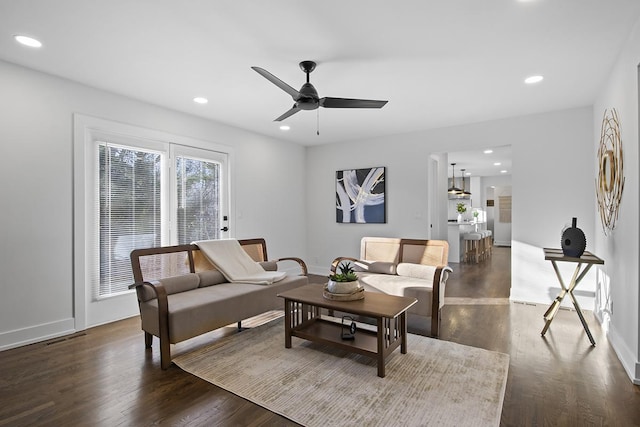 living room featuring dark hardwood / wood-style floors and ceiling fan