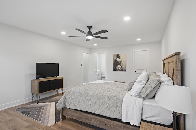 bedroom with ceiling fan, wood-type flooring, and ensuite bathroom