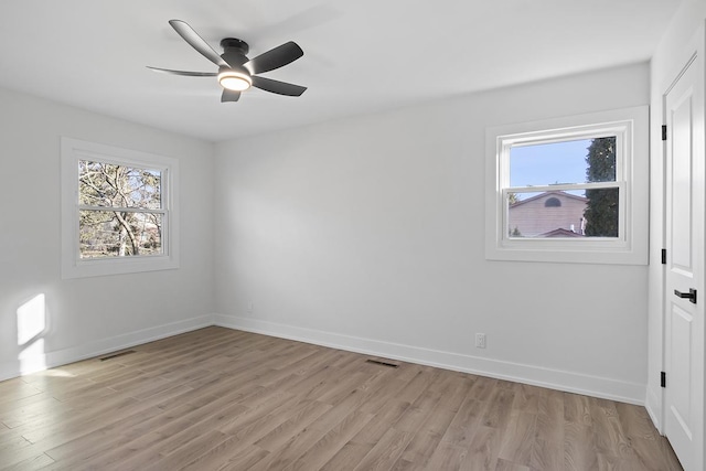 empty room with ceiling fan and light wood-type flooring