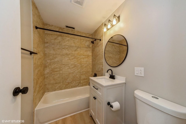 full bathroom with visible vents, toilet, vanity, shower / tub combination, and wood finished floors