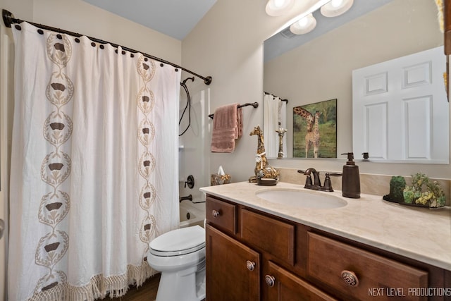 bathroom with toilet, vanity, and shower / tub combo