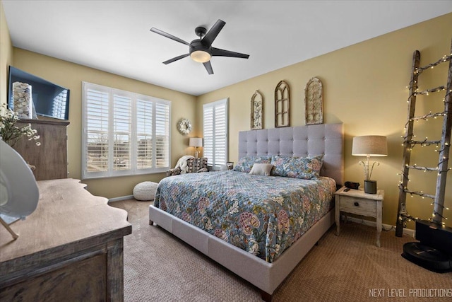 carpeted bedroom featuring baseboards and ceiling fan