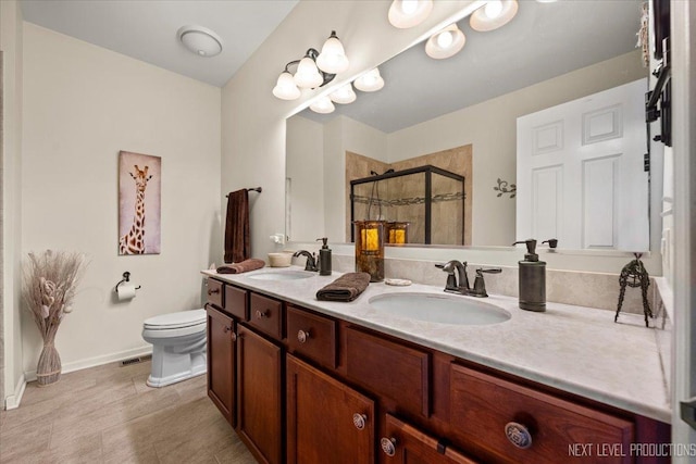 bathroom featuring a sink, visible vents, a stall shower, and double vanity