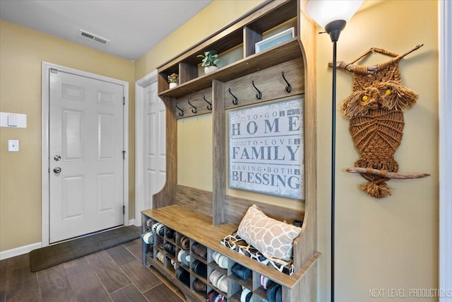 mudroom with baseboards, visible vents, and wood finish floors