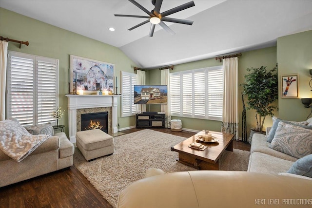 living room featuring a fireplace with flush hearth, a ceiling fan, wood finished floors, recessed lighting, and vaulted ceiling