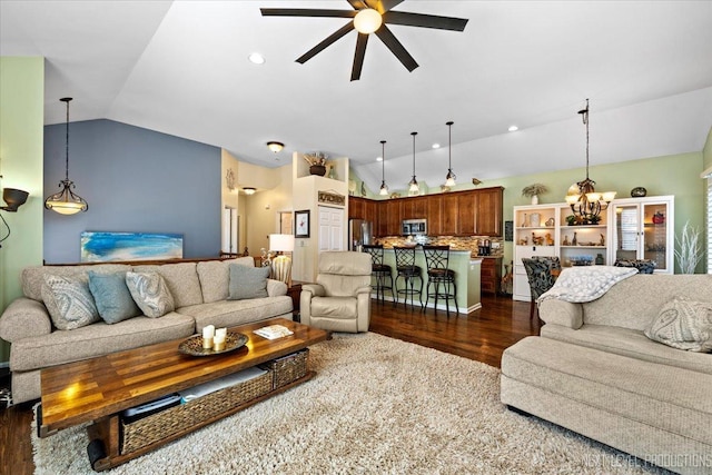 living room featuring recessed lighting, lofted ceiling, dark wood finished floors, and ceiling fan with notable chandelier