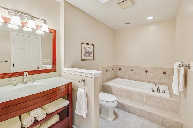 bathroom with vanity, tiled tub, tile patterned flooring, and toilet