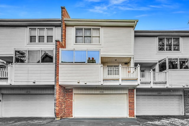 rear view of property featuring a garage