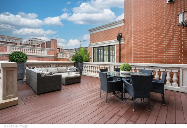 wooden terrace with outdoor dining area and an outdoor living space