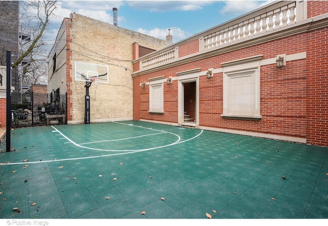 view of sport court with basketball court and fence