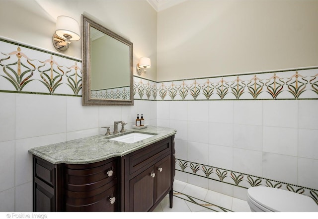 bathroom featuring vanity, tile walls, and toilet