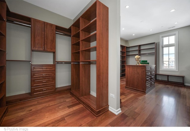 walk in closet featuring dark wood-style flooring