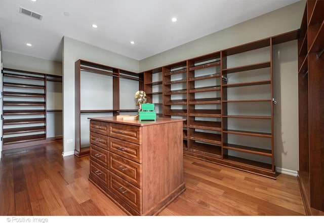 spacious closet featuring visible vents and wood finished floors