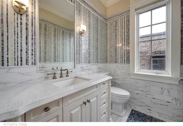 bathroom with crown molding, toilet, tile walls, and vanity