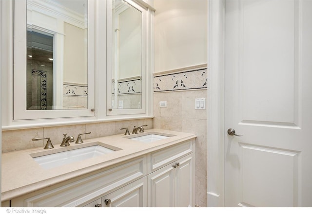bathroom featuring double vanity, tile walls, ornamental molding, and a sink