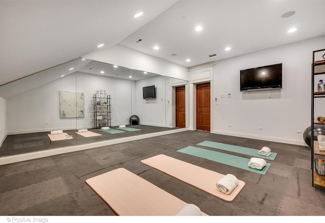 exercise area with visible vents, baseboards, lofted ceiling, and recessed lighting