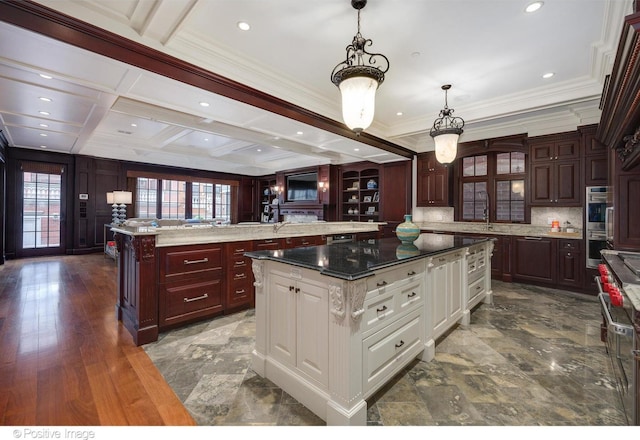 kitchen featuring tasteful backsplash, beam ceiling, a large island, stainless steel double oven, and white cabinets
