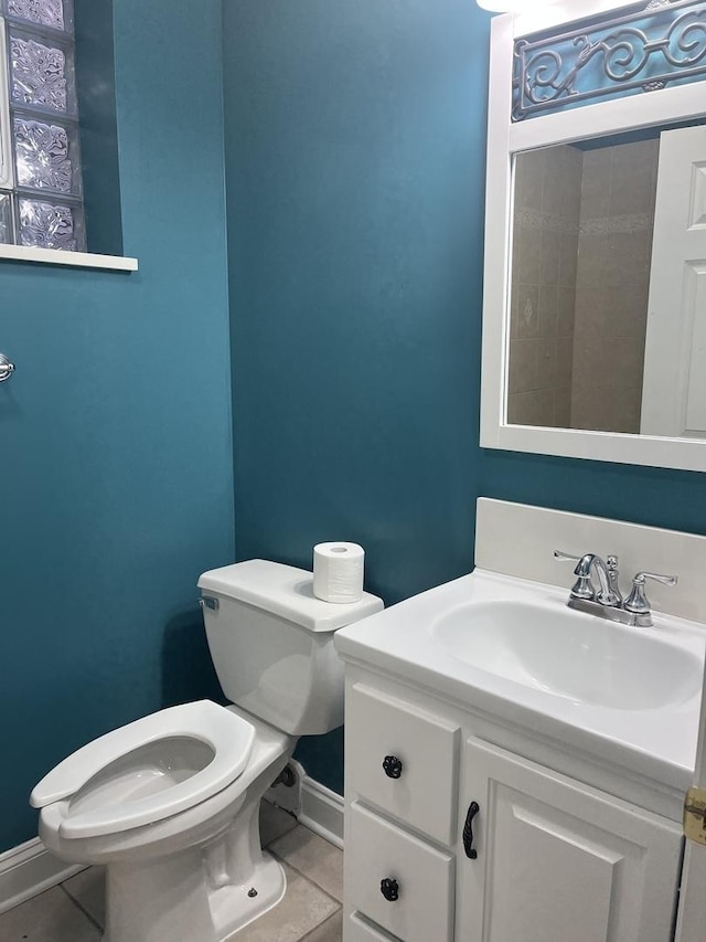 bathroom featuring tile patterned floors, toilet, and vanity