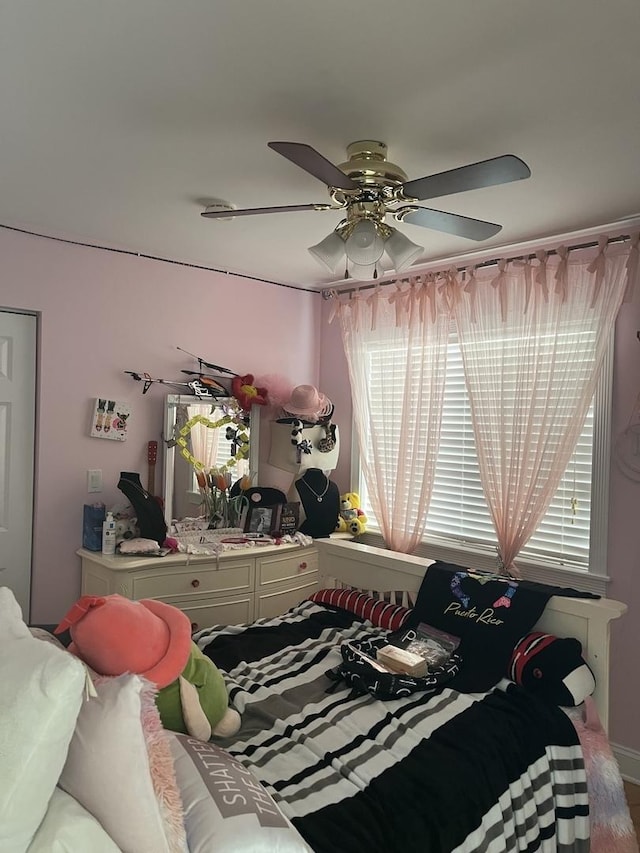 bedroom with multiple windows and ceiling fan