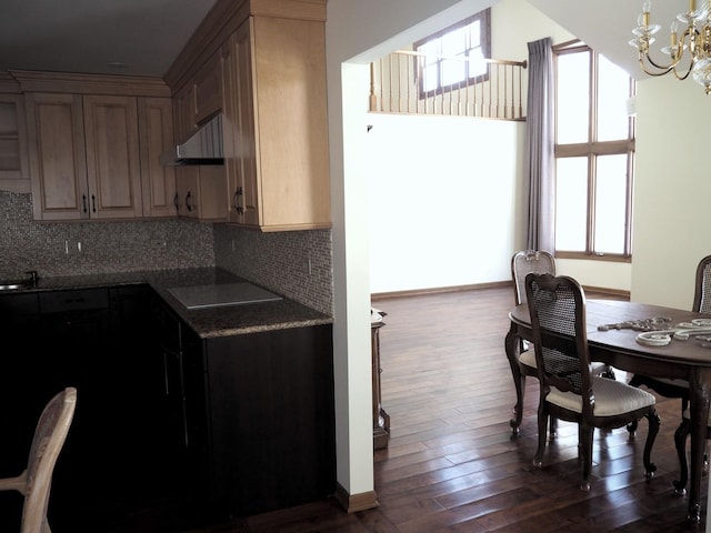 dining space featuring baseboards, a chandelier, and dark wood finished floors