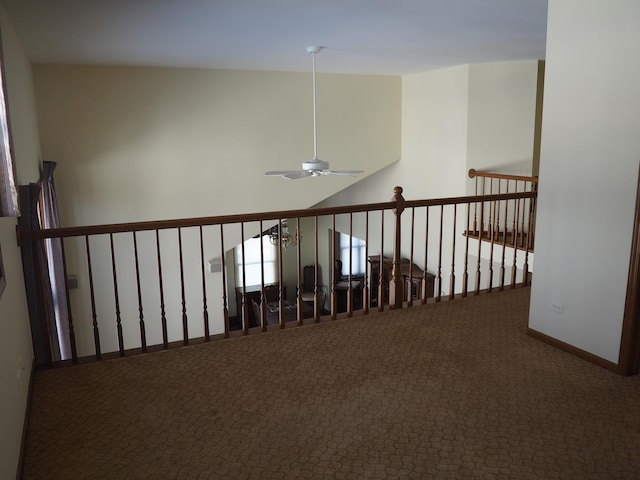 hall featuring baseboards and carpet flooring