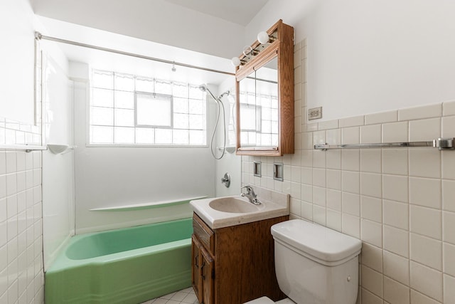 bathroom featuring tile walls, vanity, and toilet