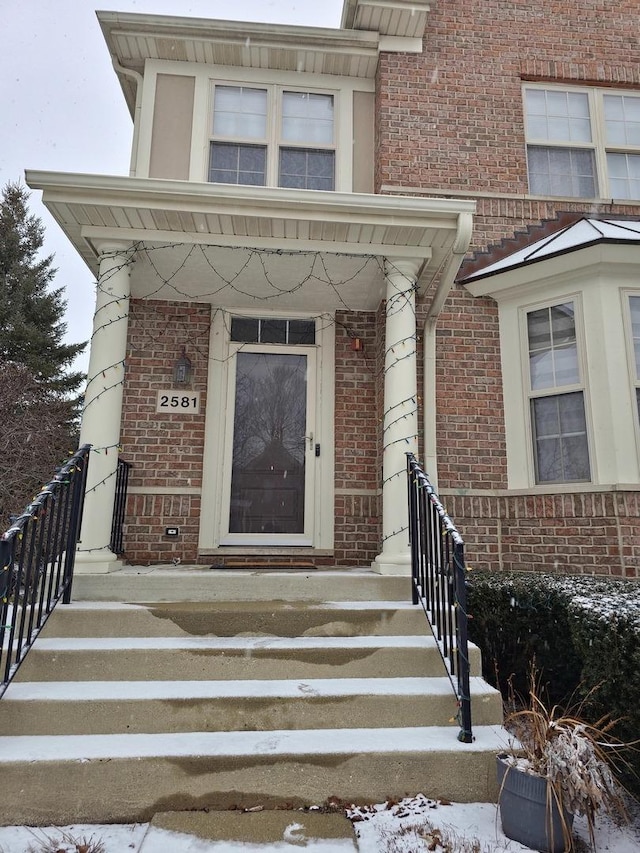 view of snow covered property entrance