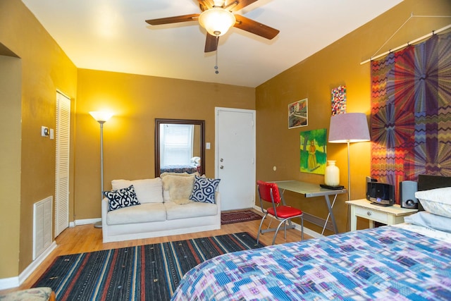 bedroom with ceiling fan, light hardwood / wood-style flooring, and a closet