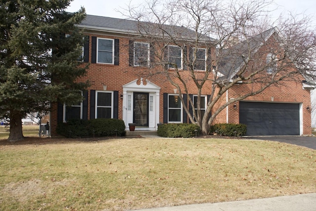 colonial inspired home featuring a garage and a front yard