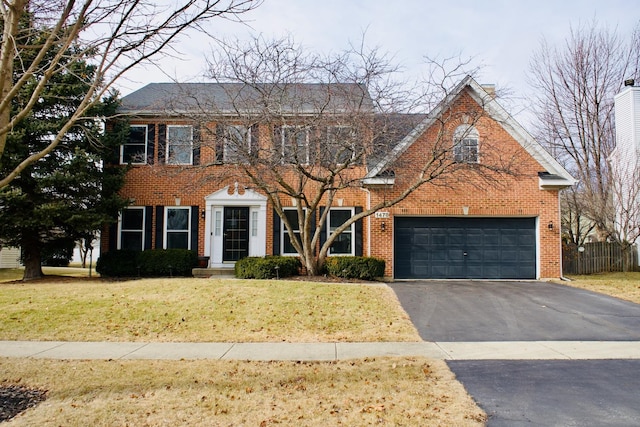 view of front of home featuring a garage and a front lawn