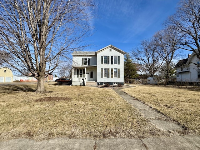 traditional-style house featuring a porch and a front yard