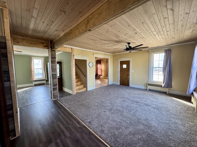 empty room featuring ornamental molding, wooden ceiling, radiator heating unit, and stairs