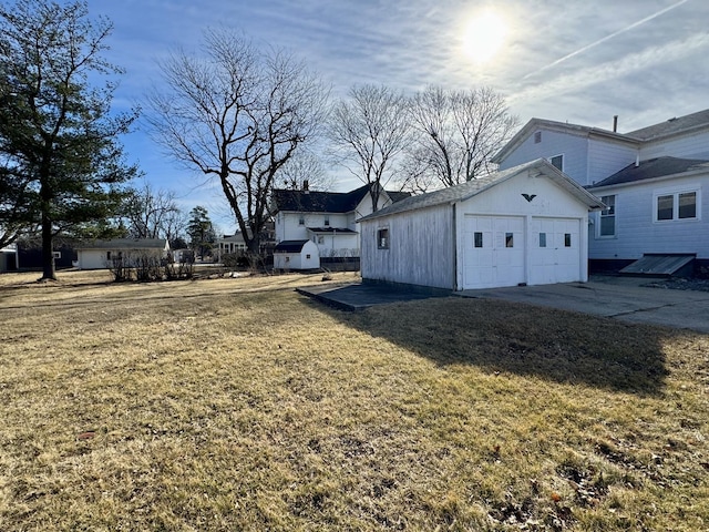 view of yard featuring an attached garage and an outdoor structure