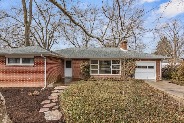 ranch-style house with a garage, driveway, a chimney, roof with shingles, and brick siding