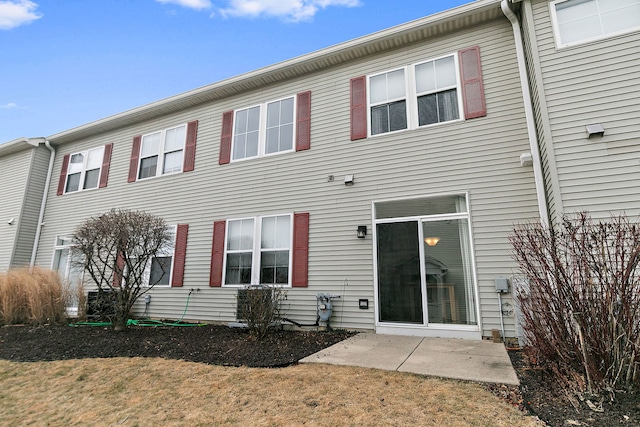 rear view of property with a yard and a patio