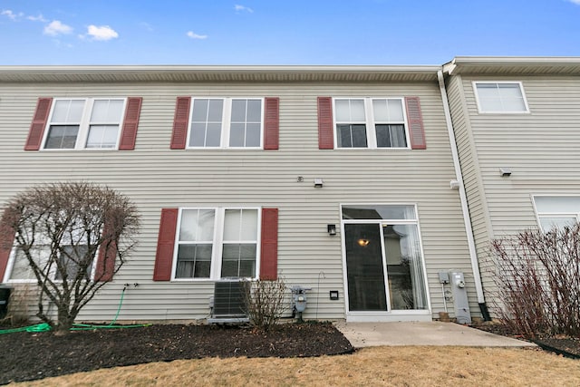 rear view of house featuring a patio and central AC