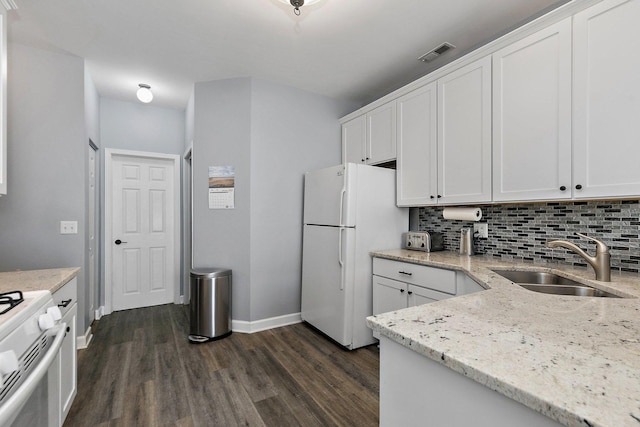 kitchen featuring sink, white cabinetry, tasteful backsplash, light stone counters, and white appliances