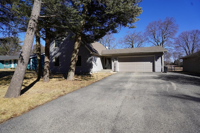 view of front of property with aphalt driveway and an attached garage