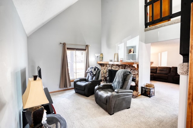 living area featuring high vaulted ceiling, carpet flooring, and a stone fireplace