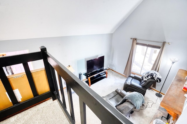 carpeted living room with lofted ceiling