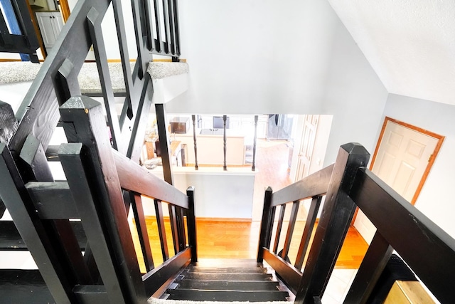 staircase featuring wood finished floors