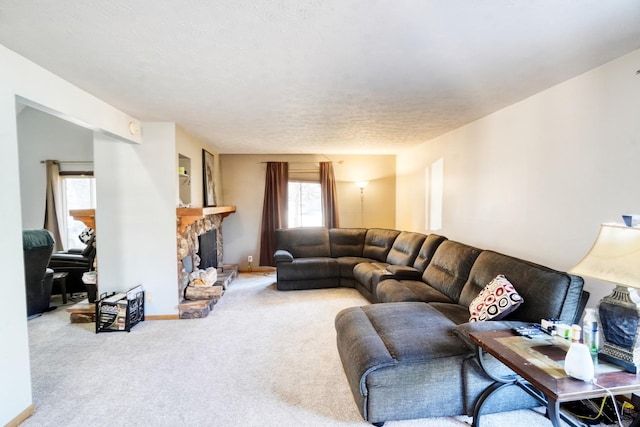 living room featuring baseboards, carpet flooring, and a stone fireplace