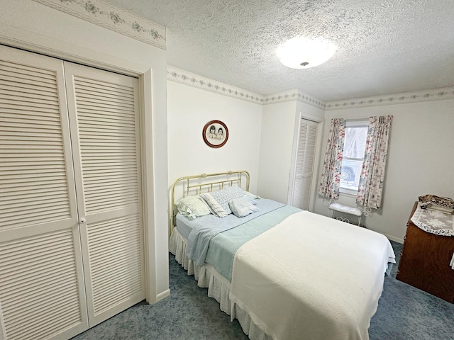 bedroom with carpet flooring, a textured ceiling, and baseboards